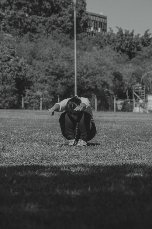 A Person Exercising on Grass