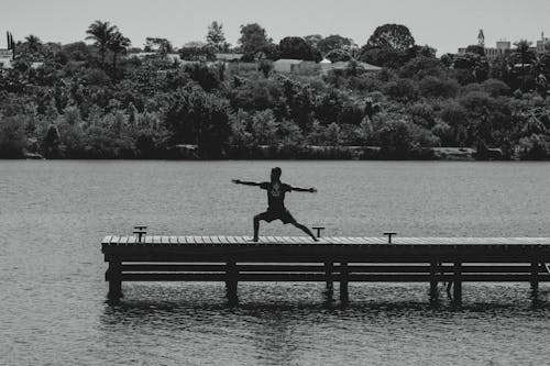 A Man Exercising on the Wooden Dock