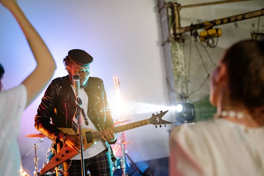 A vibrant concert scene featuring a guitarist playing an electric guitar on stage.