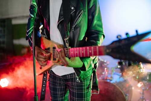 Man in Black Jacket Playing the Guitar