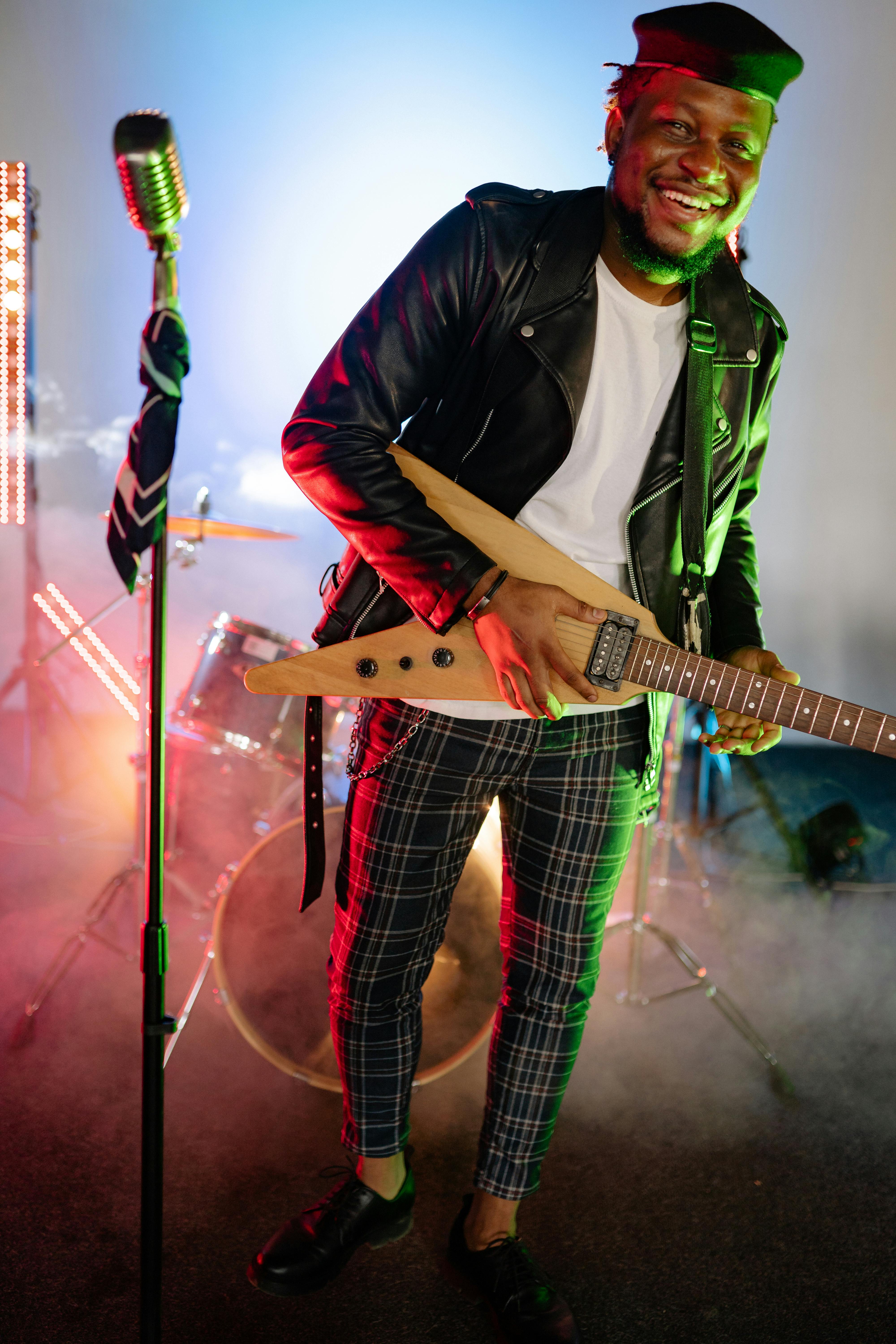 A Man in a Leather Jacket Singing · Free Stock Photo