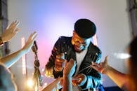 Man in Black Leather Jacket Holding String Lights