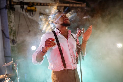 A Man in Suspenders Singing 