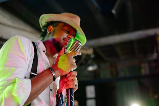 A male singer passionately performs on stage, holding a vintage microphone.