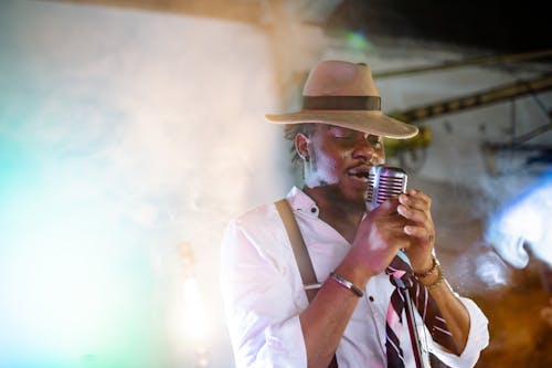 Photograph of a Man with a Brown Hat Singing