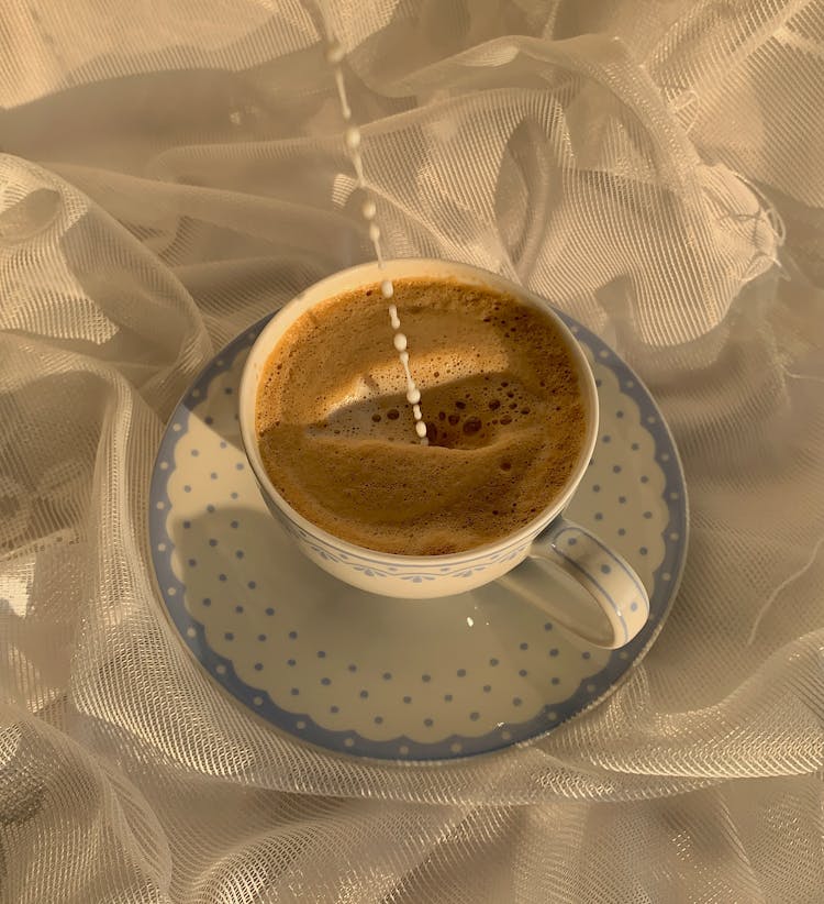 Milk Dripping On A Cup Of Coffee 