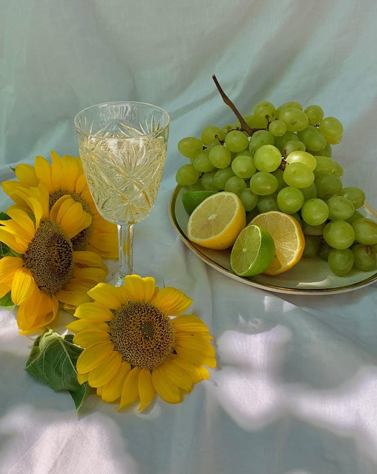 Green Grapes And Sliced Lemon On Plate 