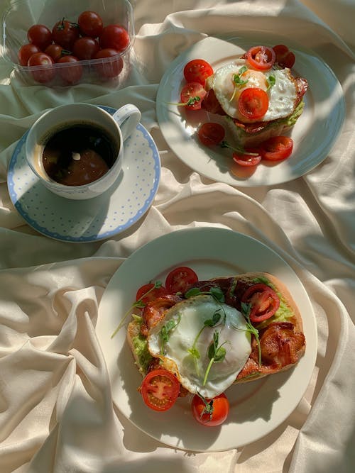 Free Bacon Egg Toasts with a Cup of Coffee on White Textile Stock Photo