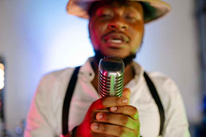 Sophie Bennett performing with a vintage microphone