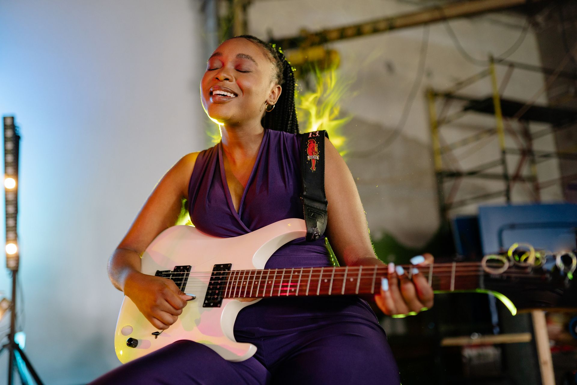 Woman Singing and Playing an Electric Guitar