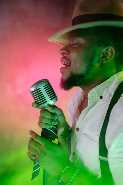 A Man Holding a Microphone While Singing