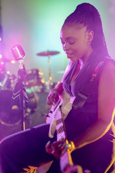 Vibrant live performance by a woman musician playing electric guitar on stage.