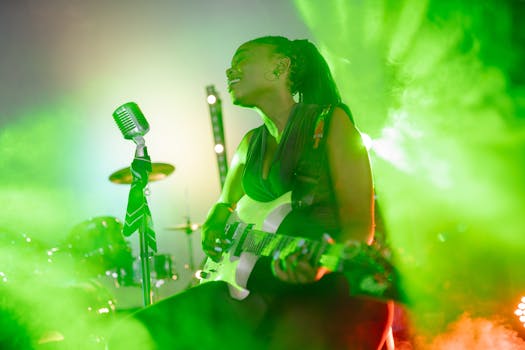 Dynamic live music performance with a female guitarist and vocalist amid vibrant green lighting effects.