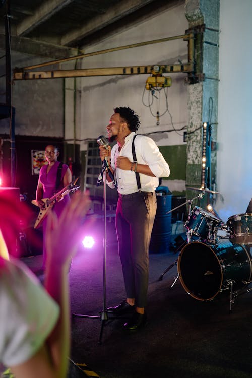 Man and Woman Singing on Stage