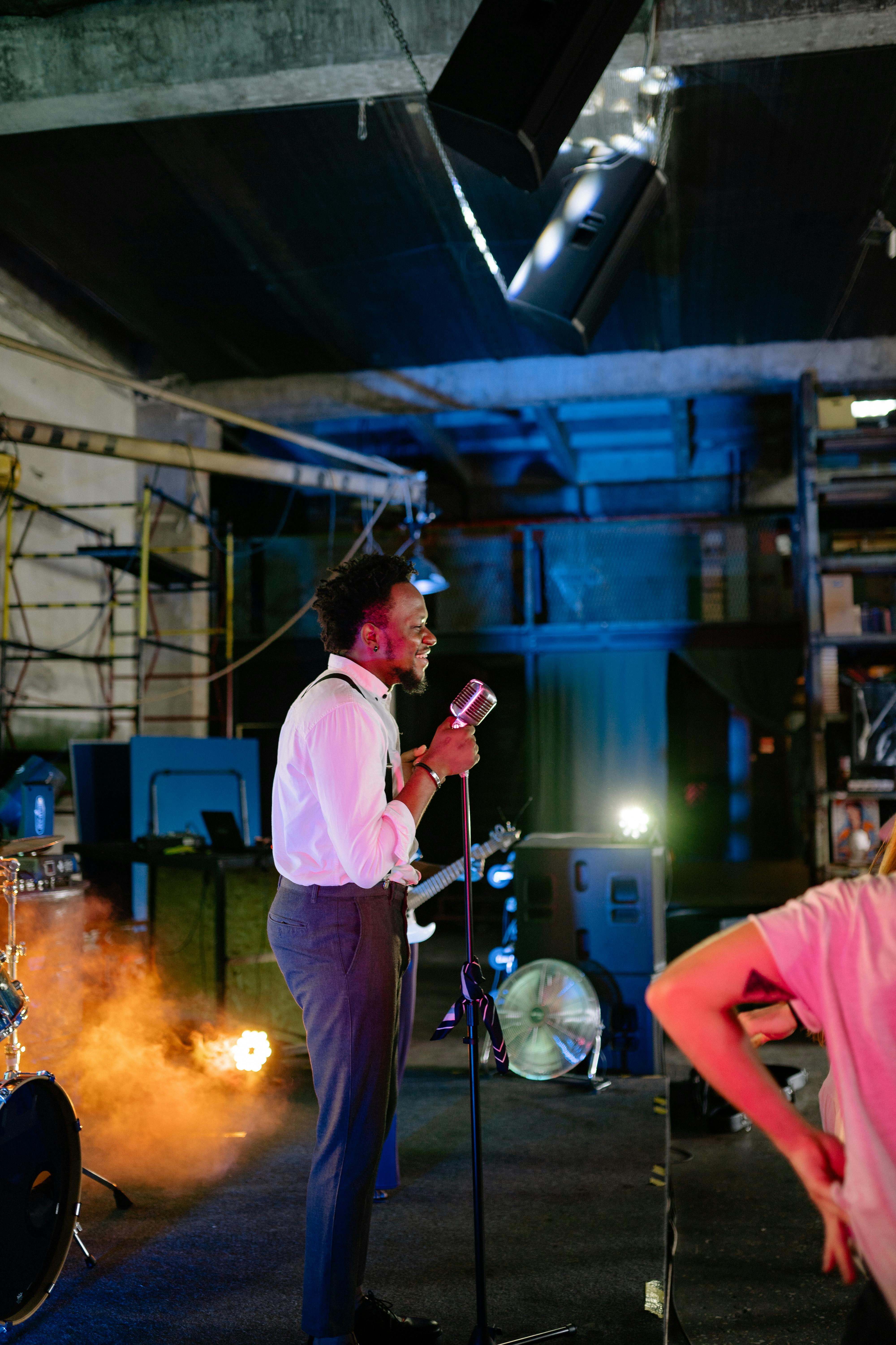 man in pink t shirt holding microphone