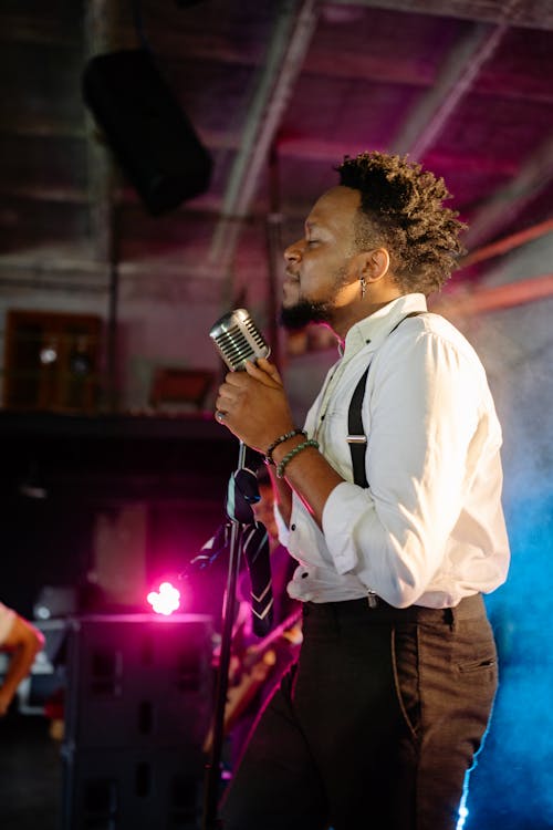 Man with a Microphone Singing on Stage