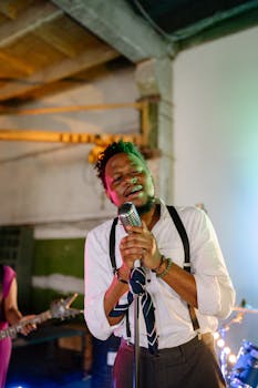 Energetic performance by a singer holding a microphone in an indoor venue.