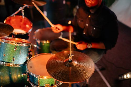 Free Close-up of a drummer passionately playing at a live music performance, capturing the rhythm and energy. Stock Photo