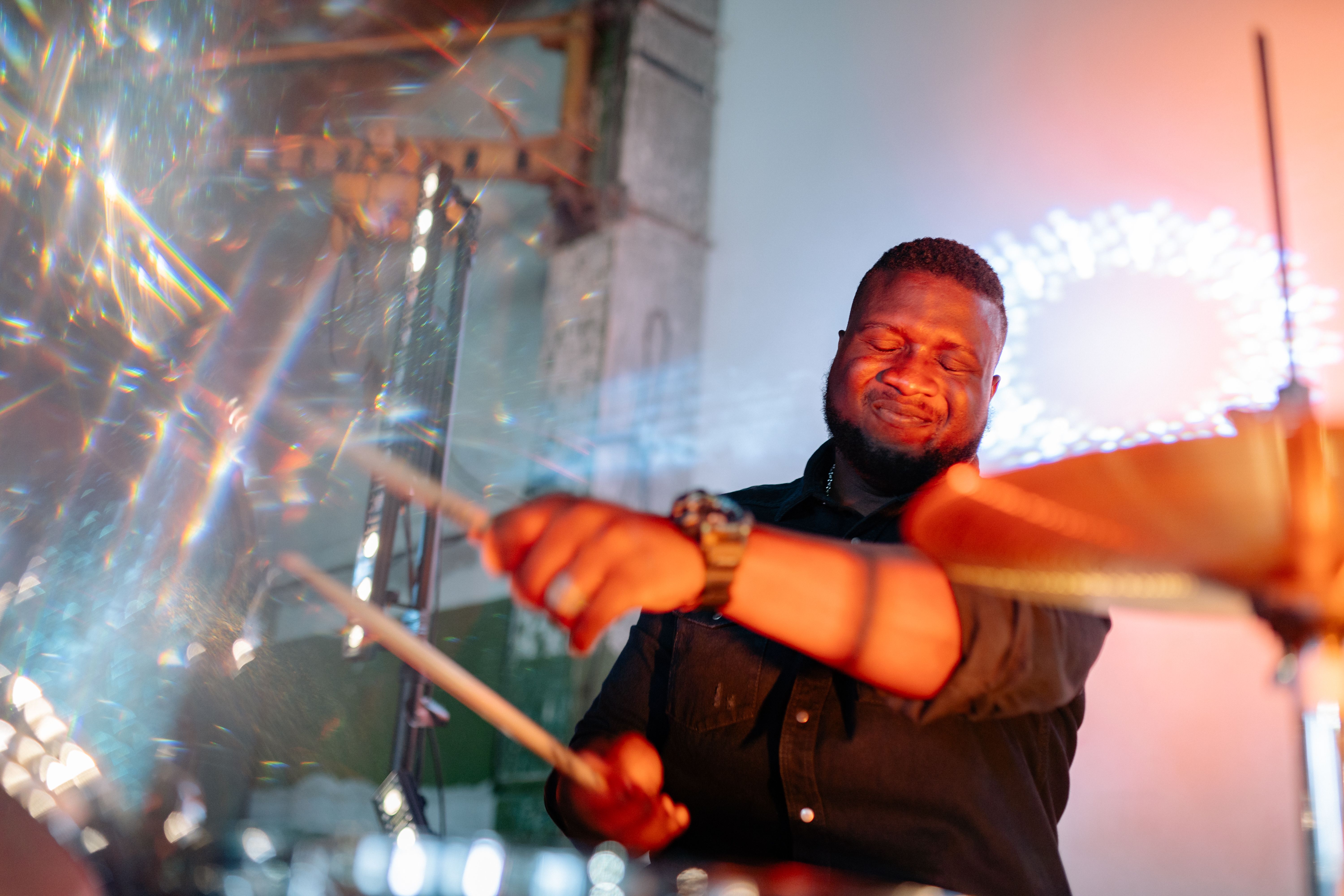 musicians making eye contact during a live performance, hands on instruments, energy visible