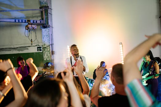 Energetic indoor music concert with a lively audience enjoying the band performance on stage.