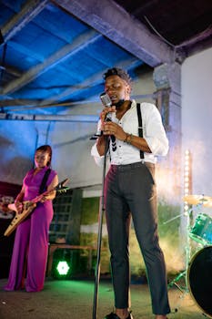 Live jazz performance with a singer and guitarist immersed in music under colorful lights.