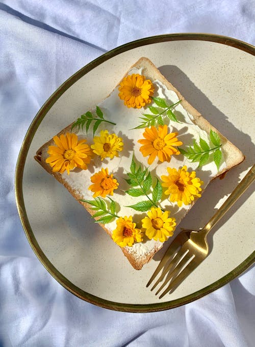 Free Toast with Orange Flowers on Plate Stock Photo