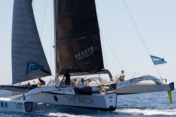 People Sailing In The Arch Catamaran Sailboat