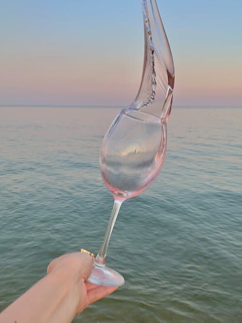 Free Rose Wine Splashing from a Wine Glass Stock Photo
