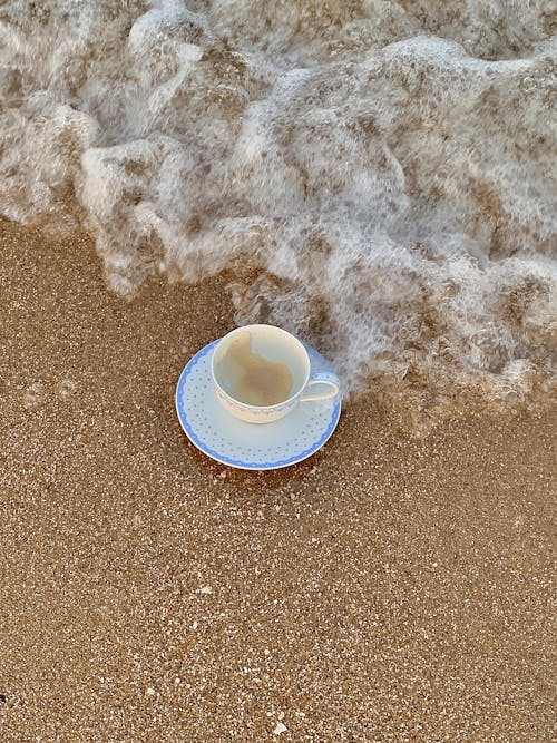 A Cup and a Saucer on the Sand