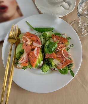 Delicious smoked salmon with avocado toast garnished with fresh greens, ideal for breakfast or brunch.