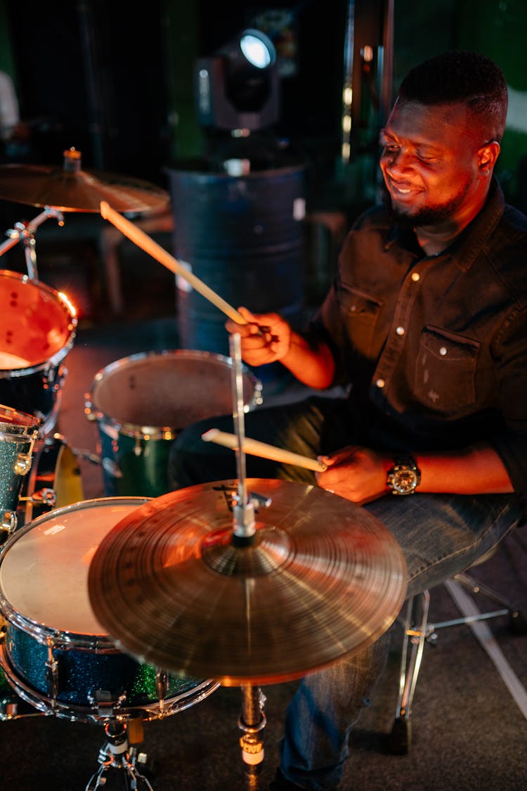 Man Wearing Black Shirt Playing The Drums