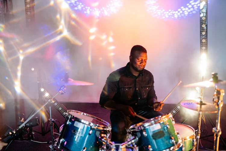 Photograph Of A Man In A Black Jacket Playing The Drums