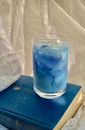 A Glass of Cold Drink on Top of a Book