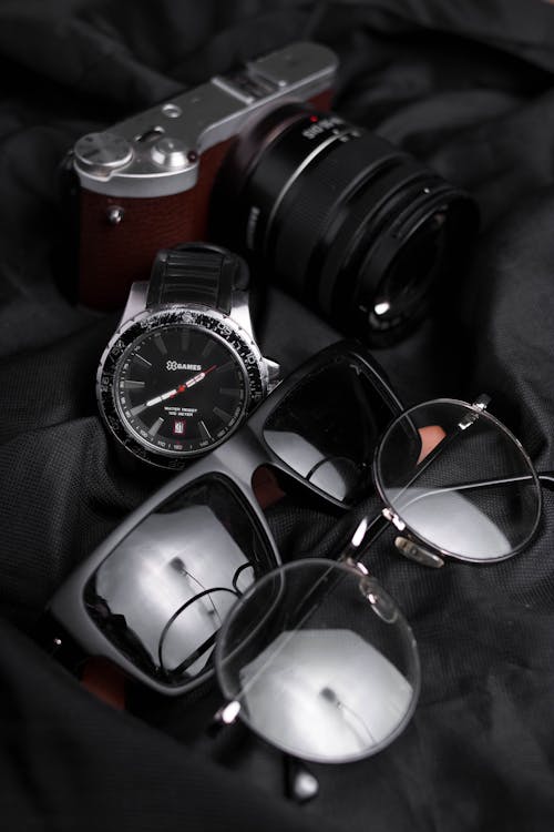 Wristwatch and Eyewear on Black Fabric