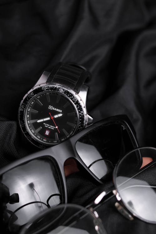Close-Up Shot of Sunglasses and a Wristwatch 