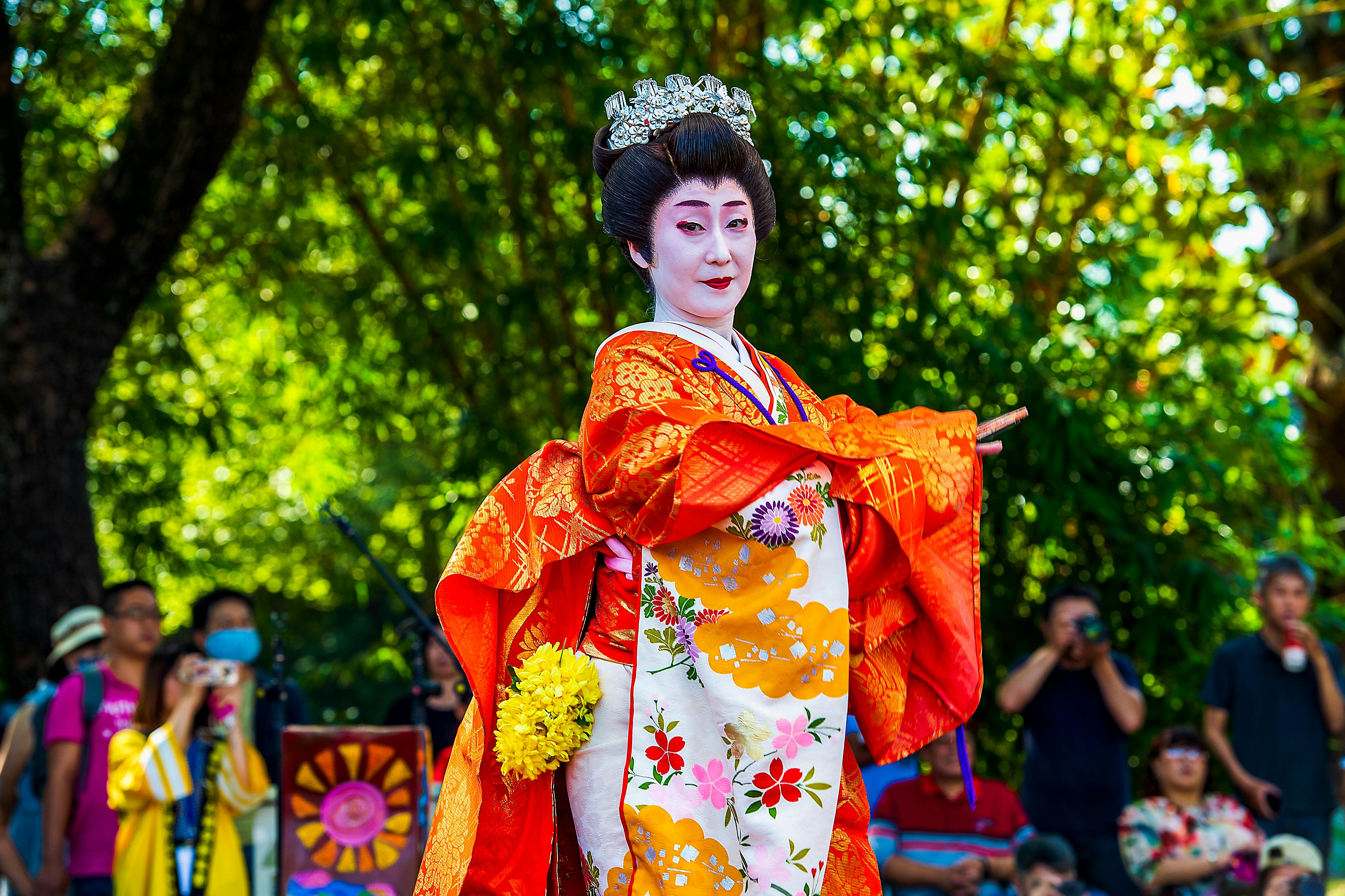 Free Woman in Red Kimono Standing Near Green Trees Stock Photo