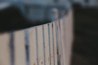 Selective Focus Photograph of a White Wooden Fence
