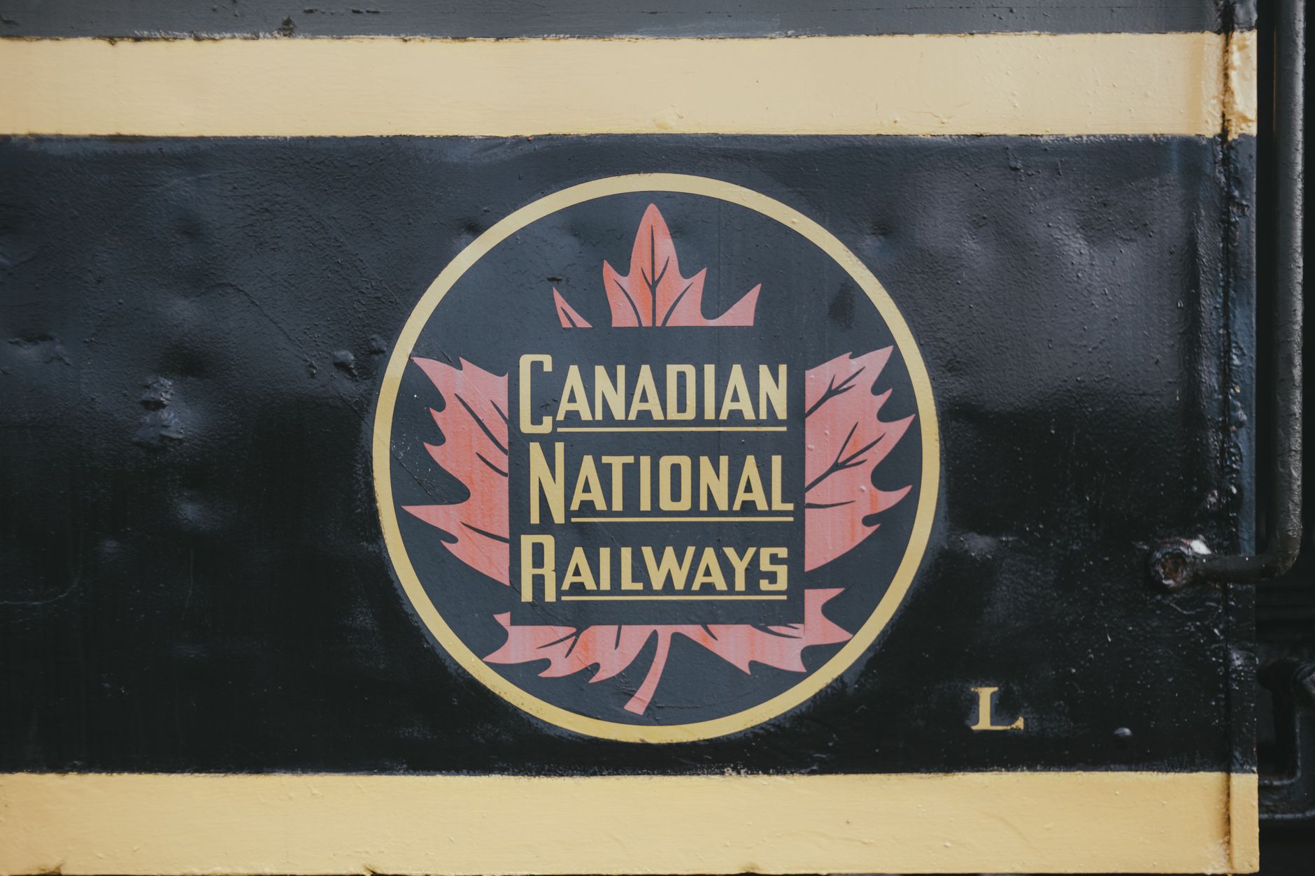 Close-up of the Canadian National Railways logo on a vintage train metal surface.