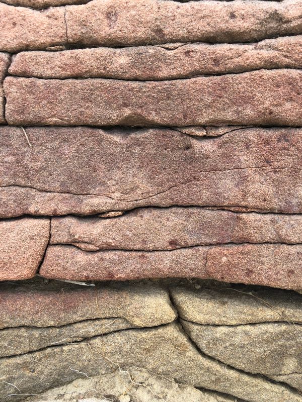 Close-up of a layered sandstone wall. Photo by Kate Gundareva on Pexels.