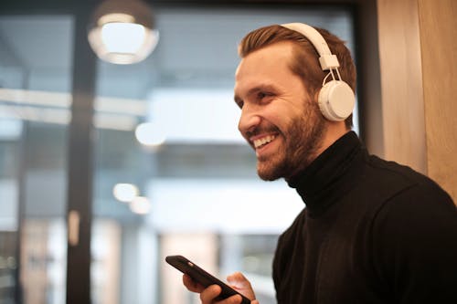 Free Man Wearing White Headphones Listening to Music Stock Photo