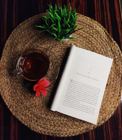 Tea on Glass Cup and an Open Book