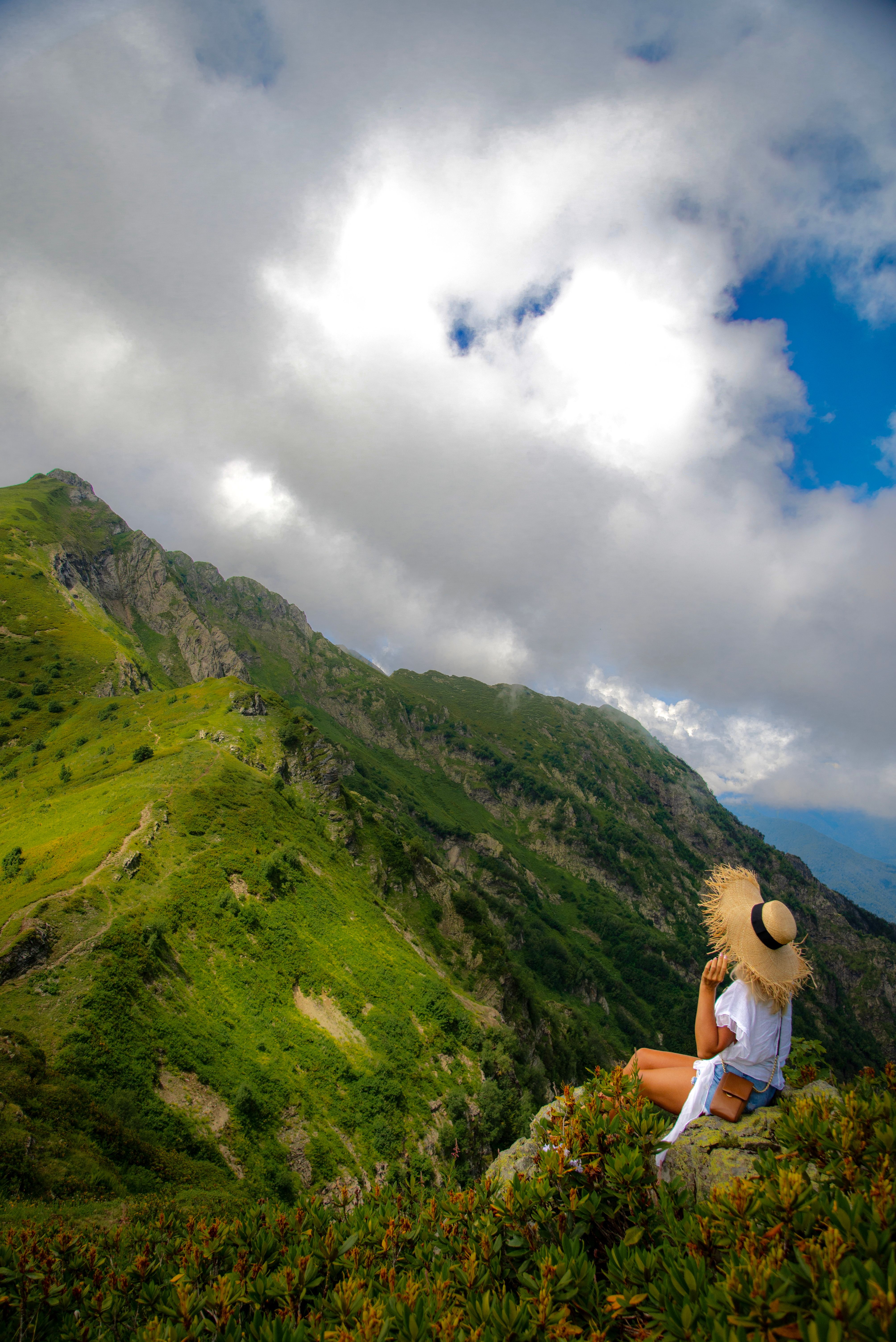 Woman in White Top Sitting on a Rock · Free Stock Photo