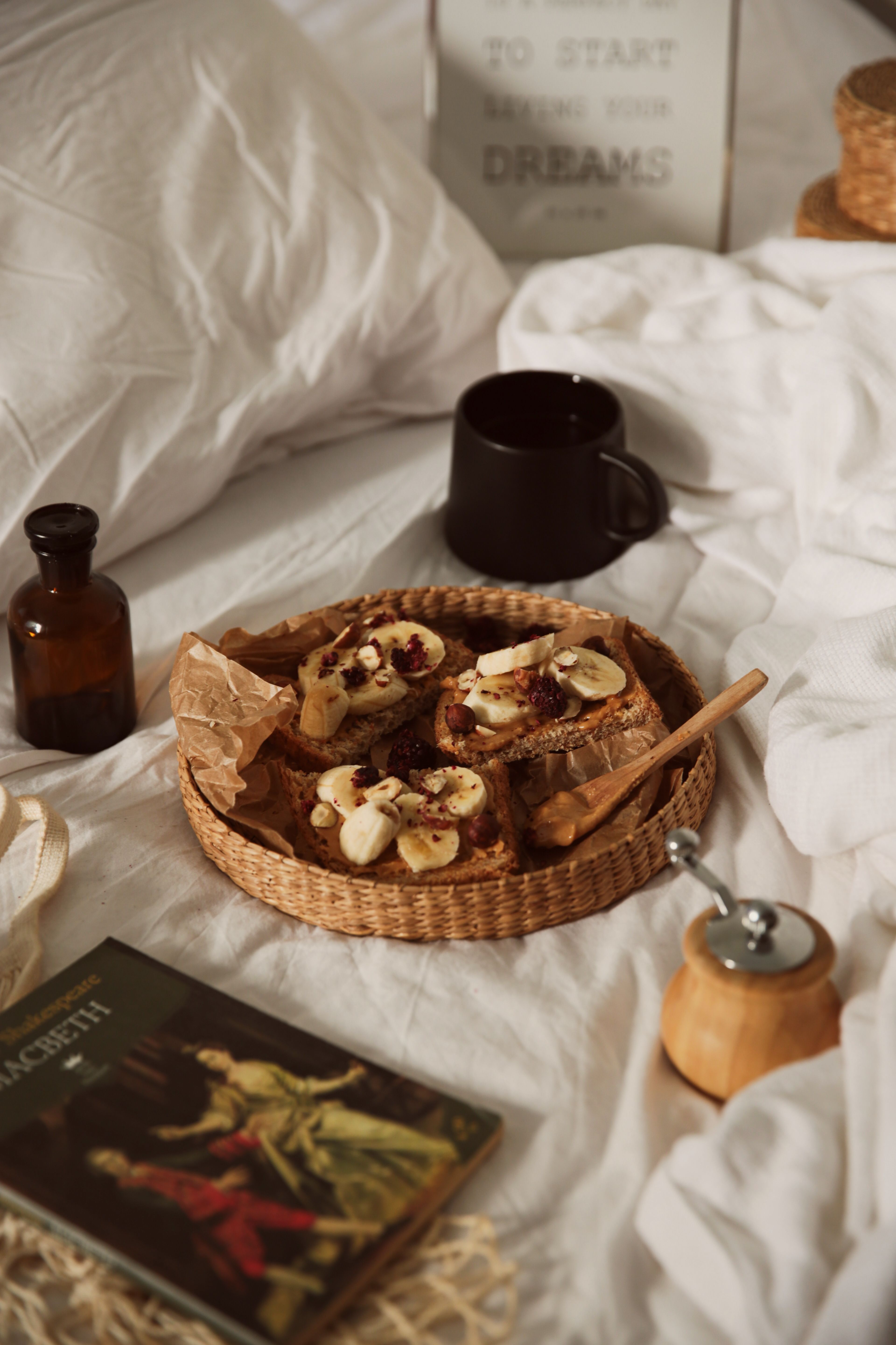 A warm breakfast tray with banana toast on a cozy bed setting.