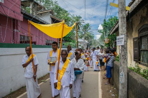 Free Cultural Buddhist procession on Mirissa street showcasing vibrant traditions and community spirit. Stock Photo