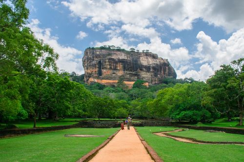 Free Sigiriya Rock Fortress towering over lush green landscape, a famous UNESCO World Heritage site in Sri Lanka. Stock Photo