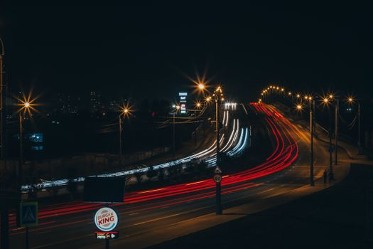 Captivating night scene capturing vibrant light trails on a bustling city road.
