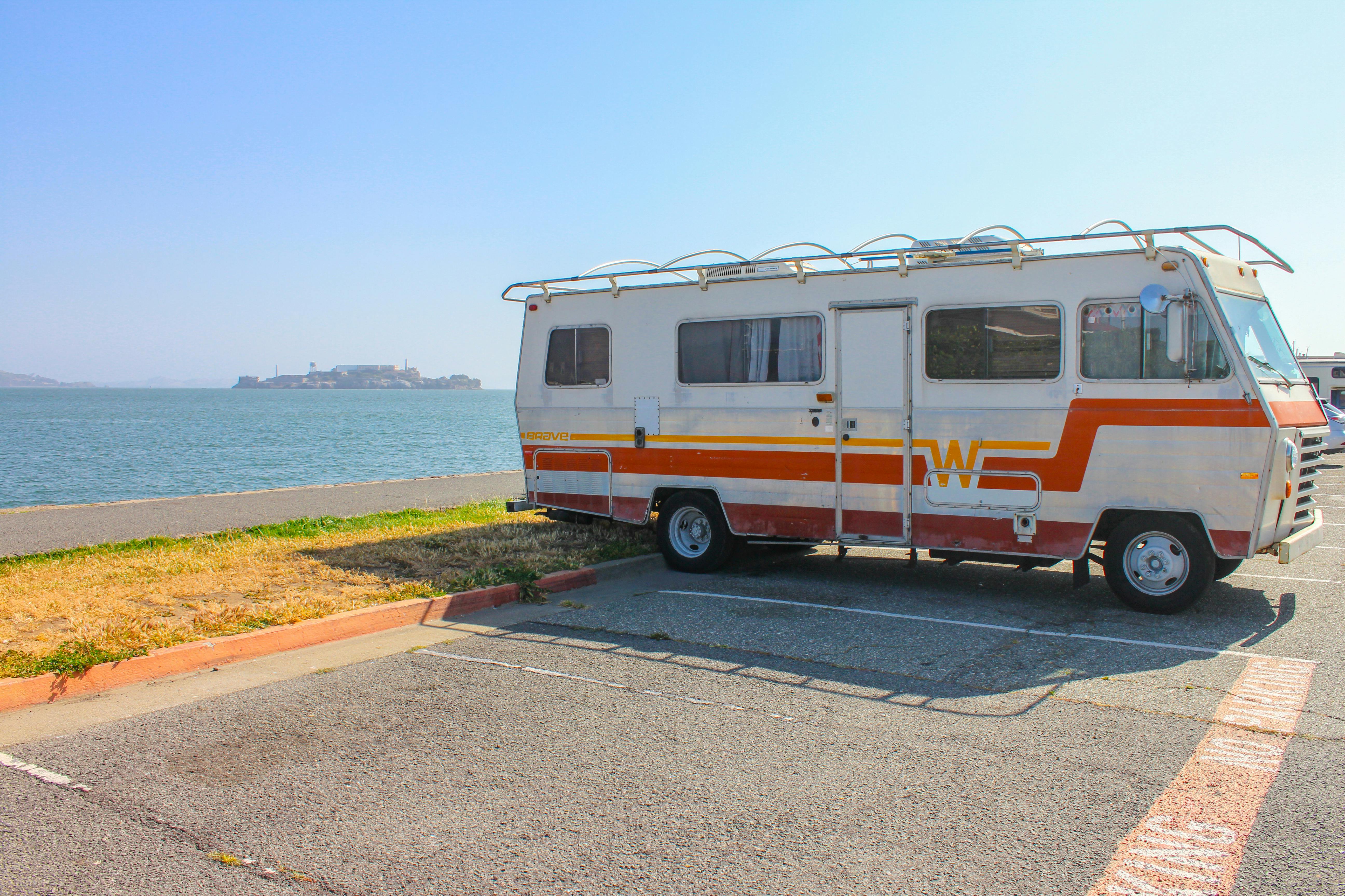 Free Trailer Van parked alongside Ocean Stock Photo