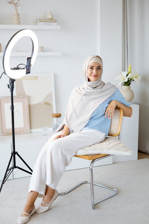Woman in White Hijab Sitting on Chair