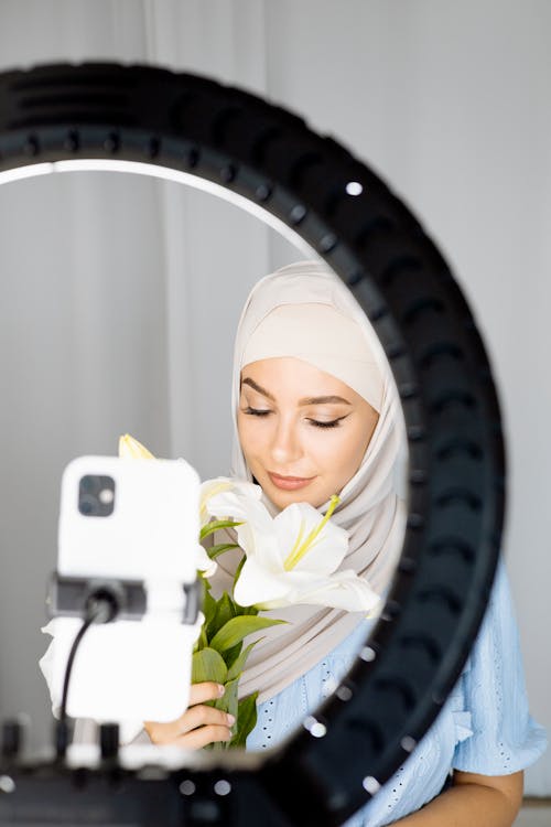 Free Woman in White Hijab Holding White Smartphone Stock Photo