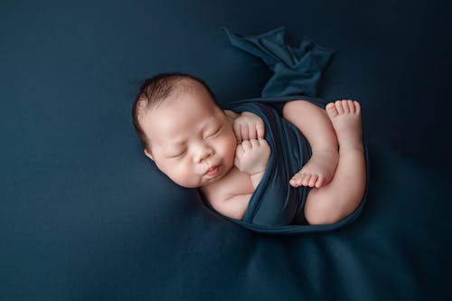Close-up of a Cute Baby in Blue Cloth